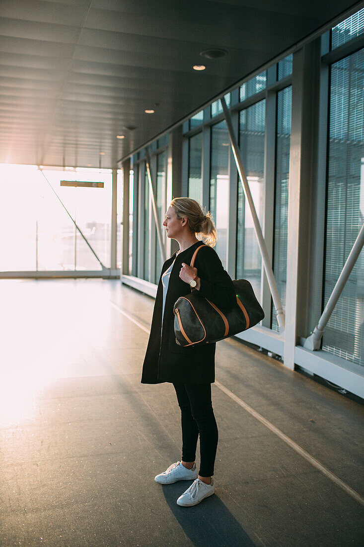 Woman standing with bag