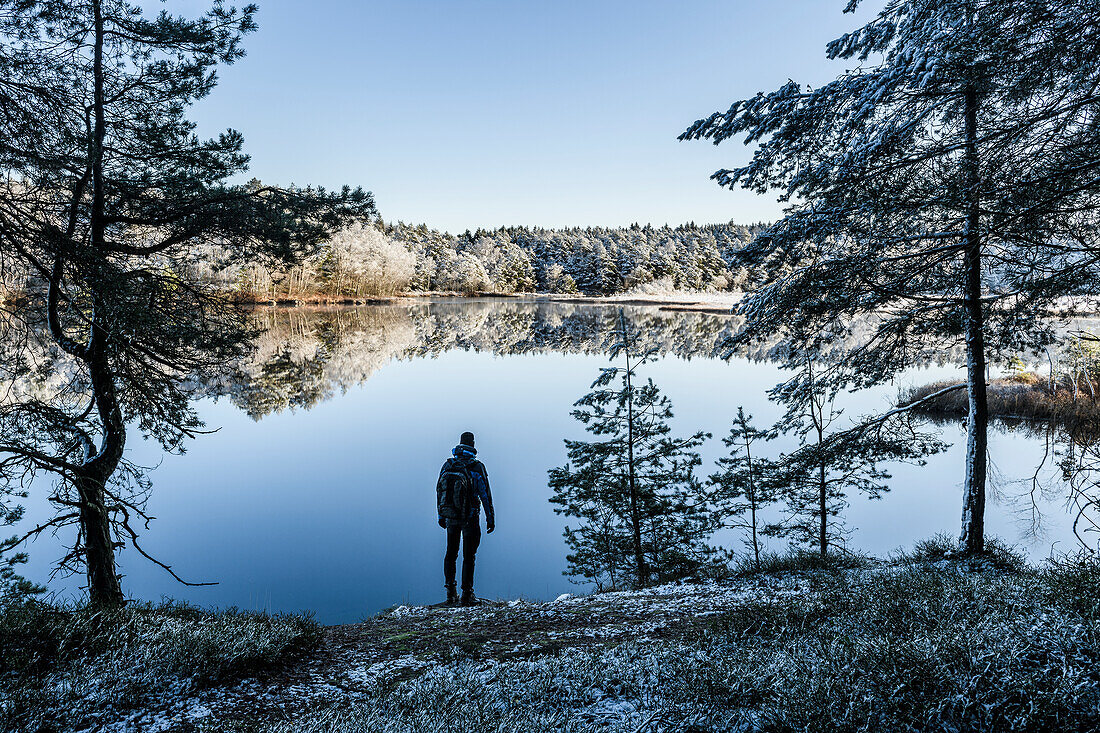 Man looking at lake in winter