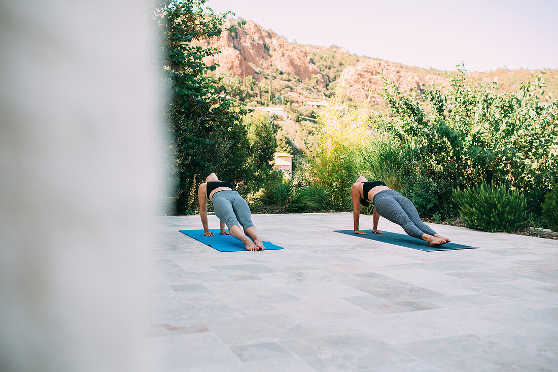 Two women exercising on veranda