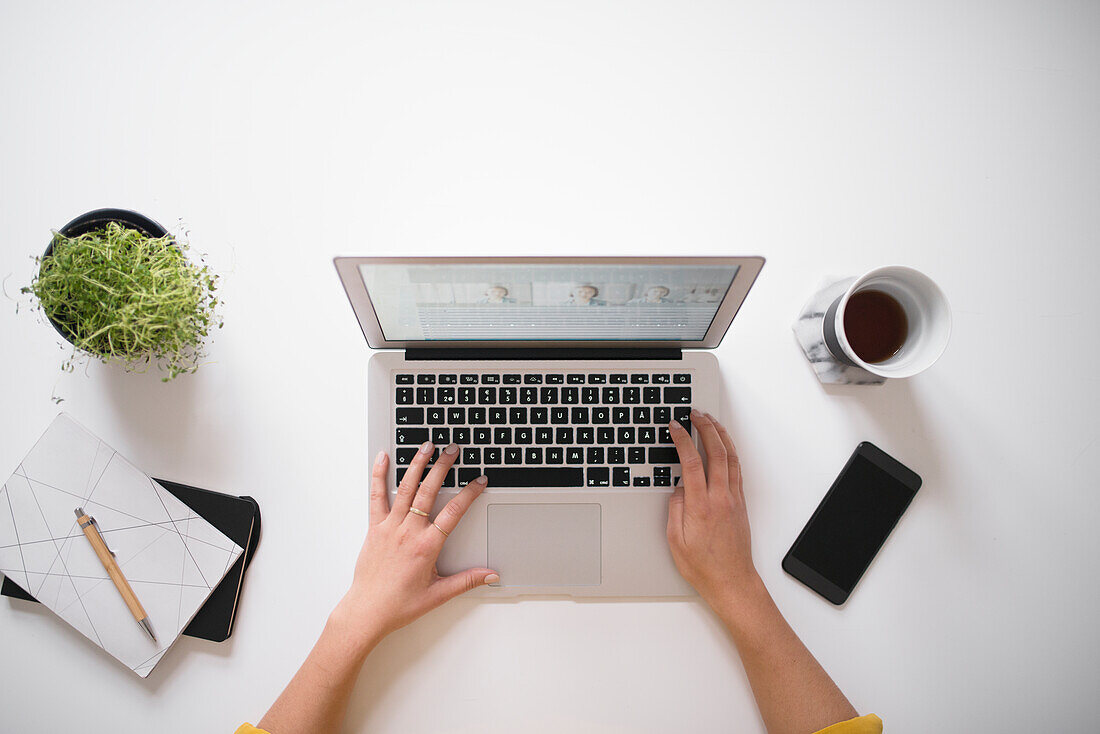 Womans hands using laptop