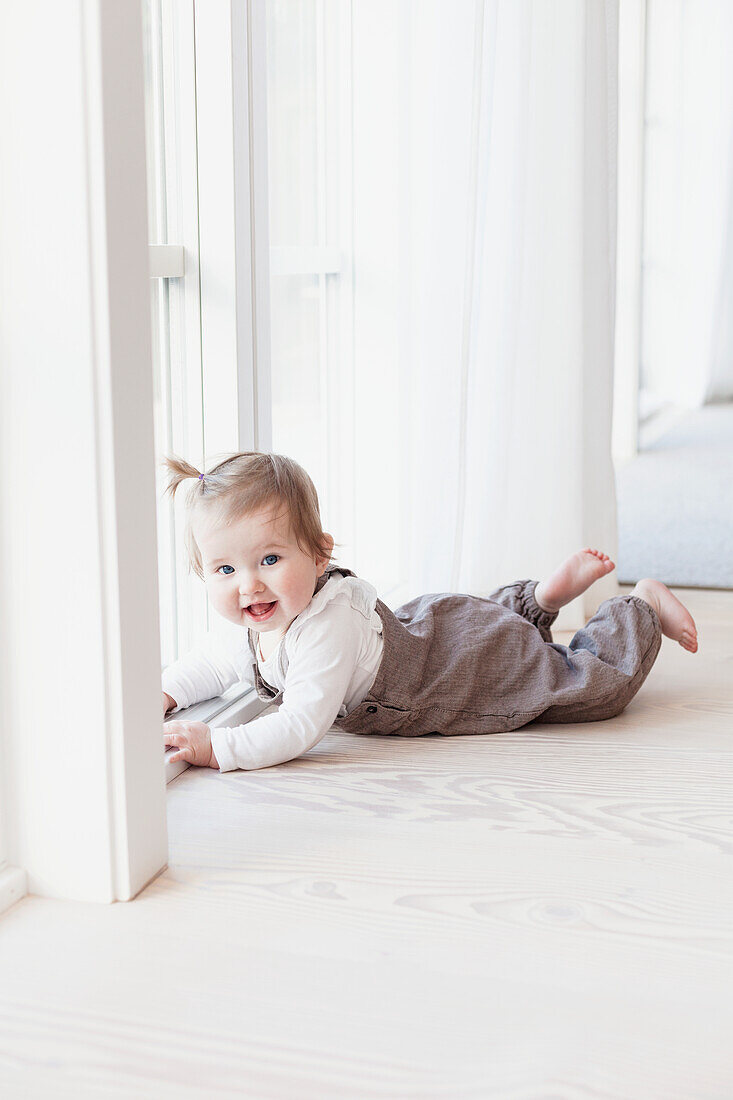 Baby girl crawling on floor