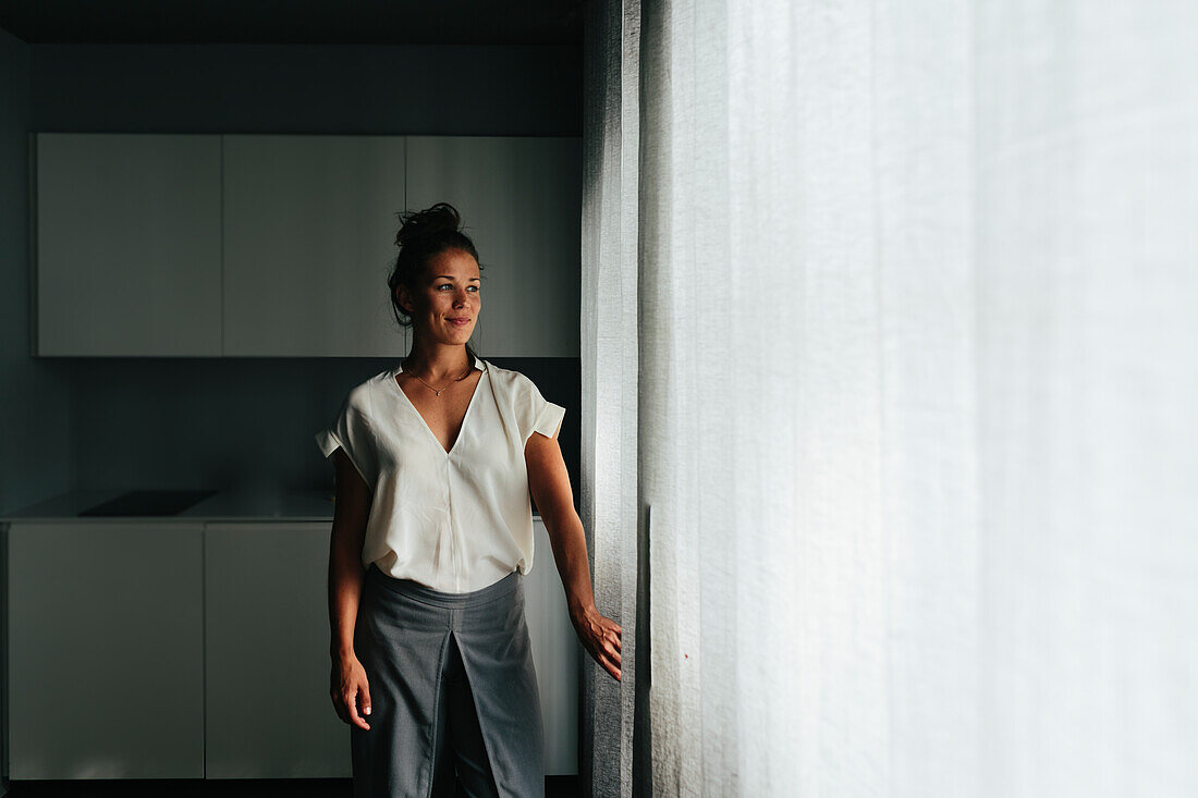 Woman looking through window