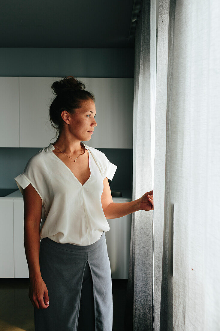 Woman looking through window