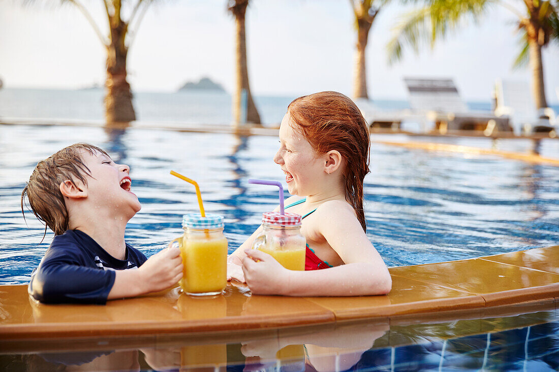 Happy boy and girl in swimming-pool