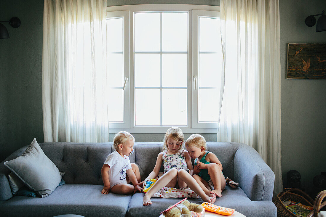 Kids on sofa using tablet