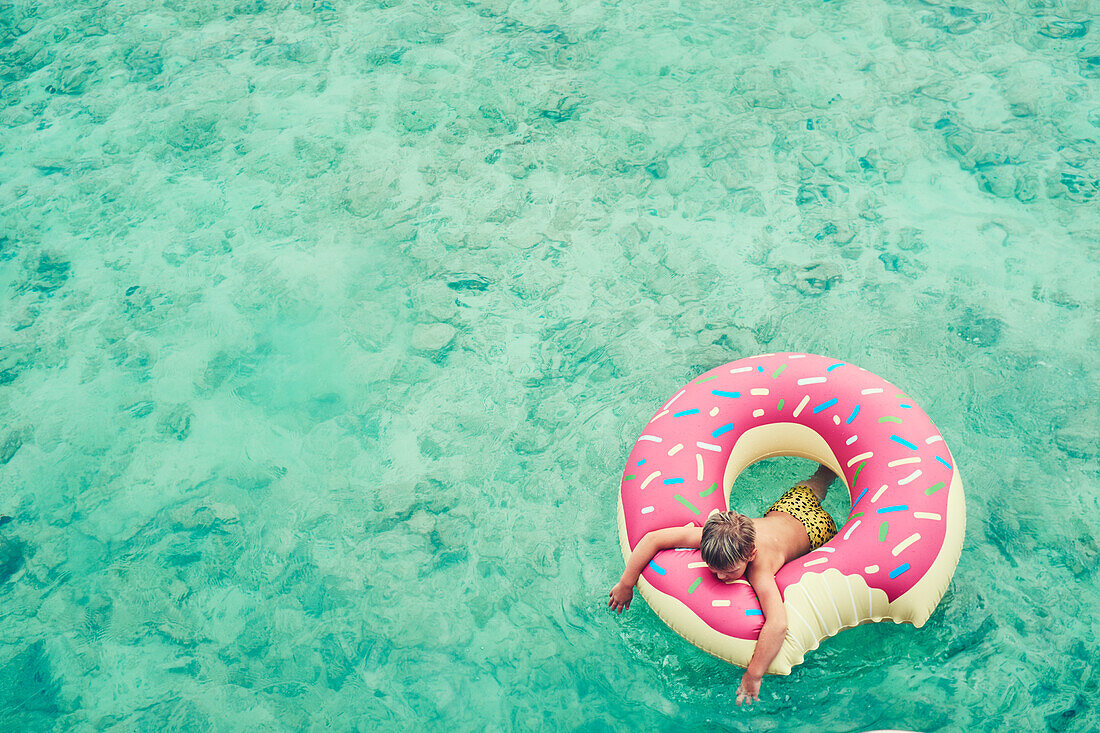 Boy swimming on inflatable ring