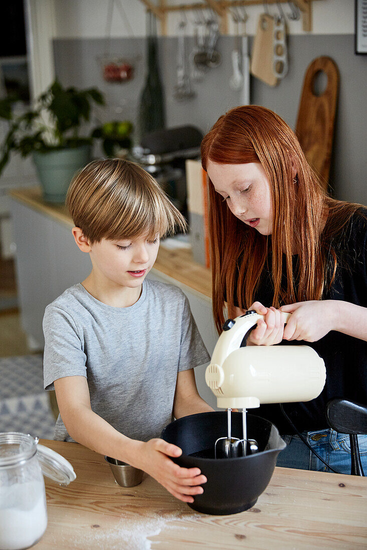 Children using electric mixer