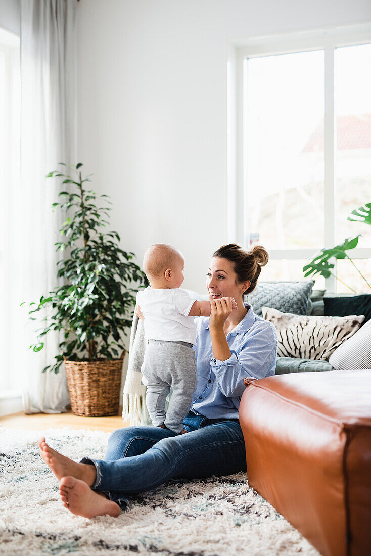 Mother playing with baby boy