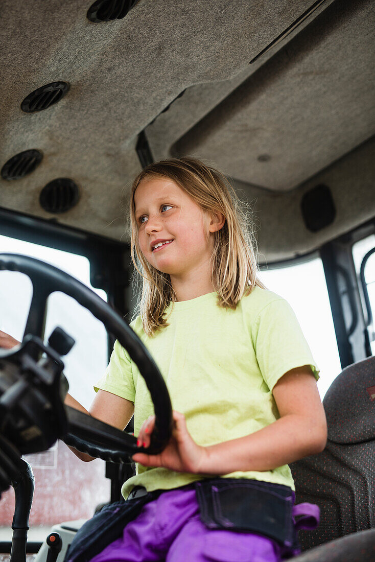 Girl driving tractor