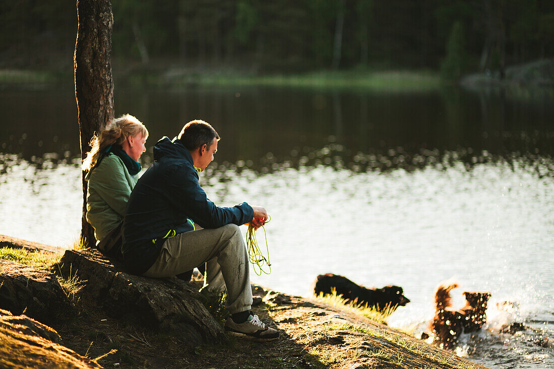 Couple sitting at lake