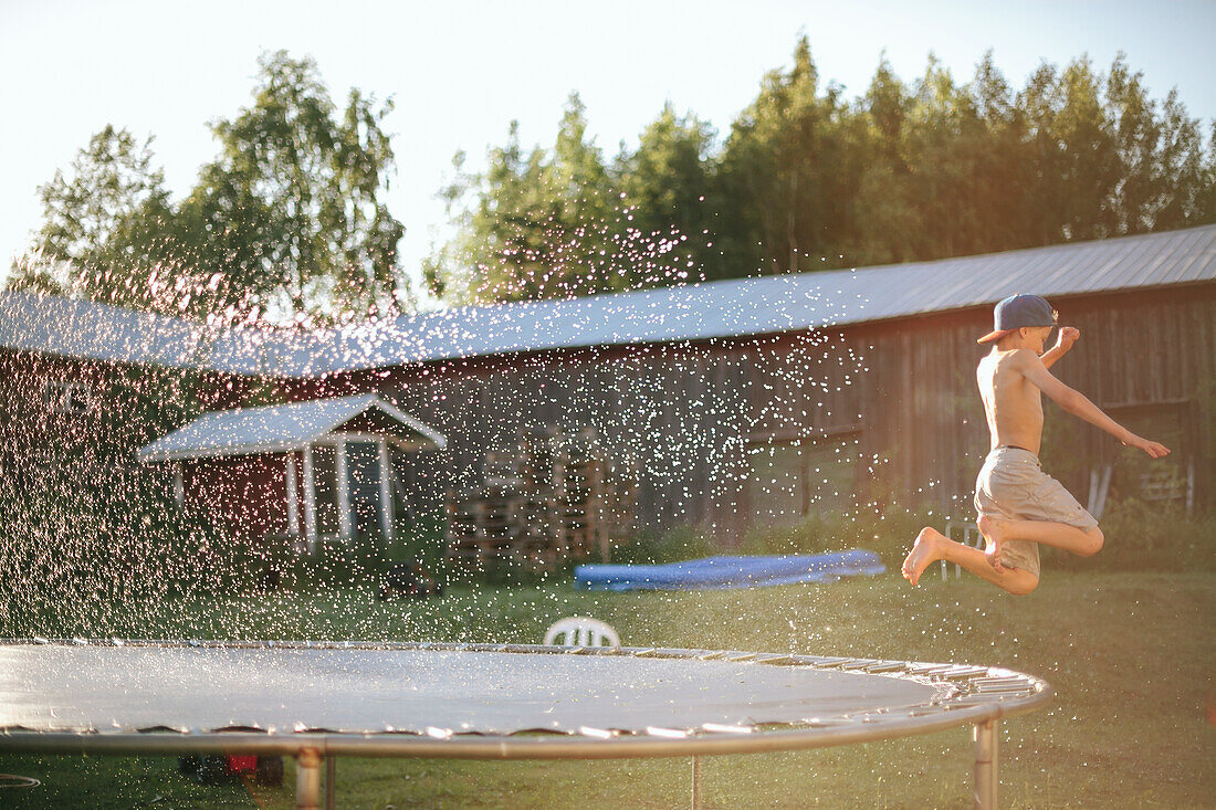 Boy jumping in garden
