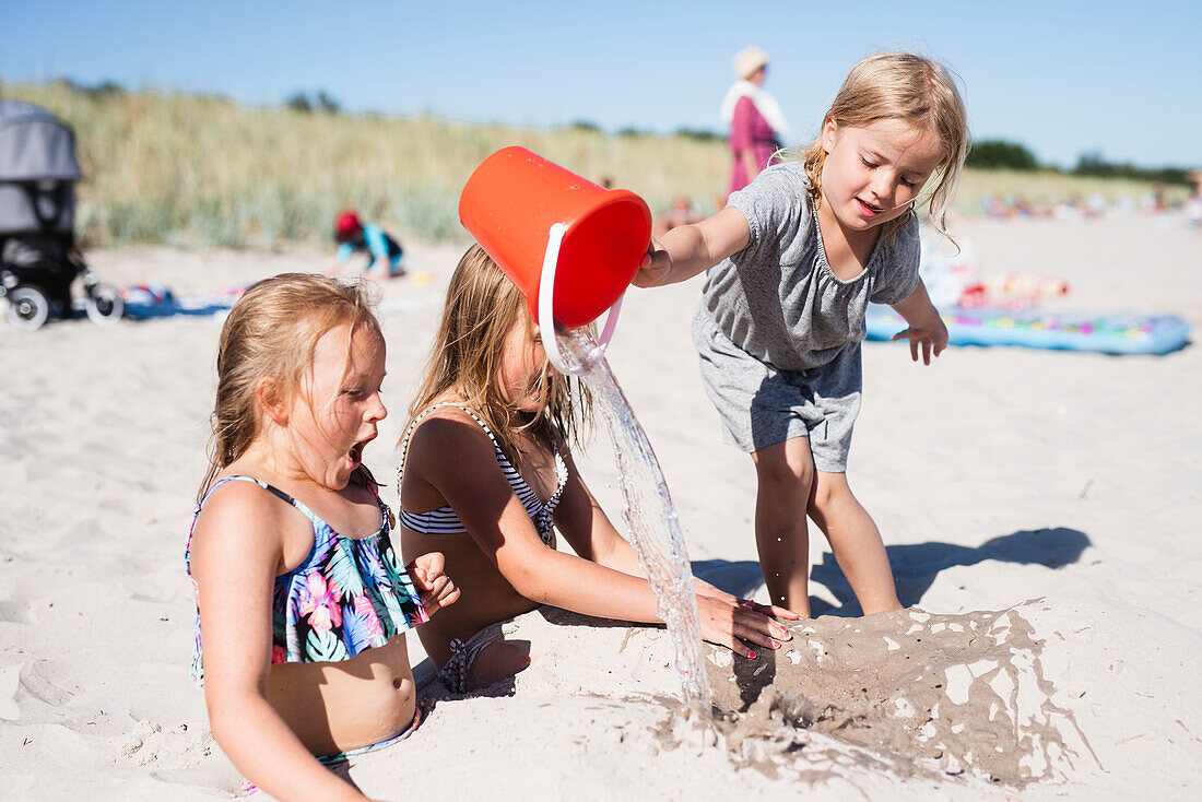 Girls playing on sandy beach