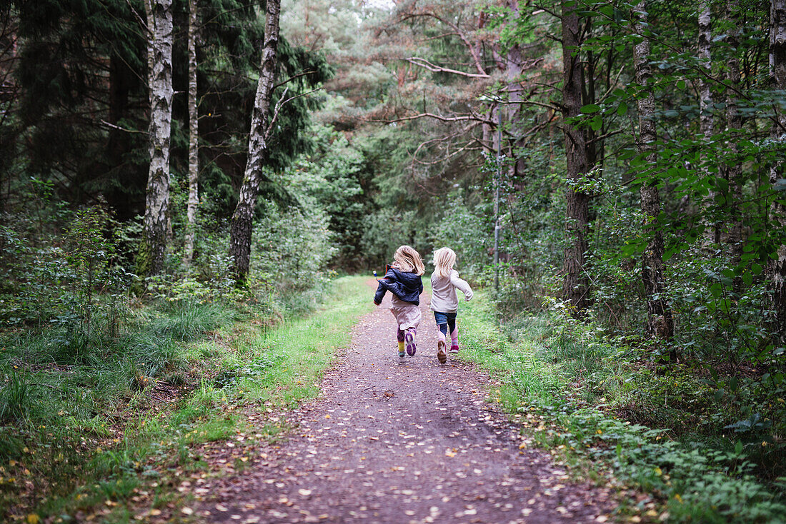Girls running through forest