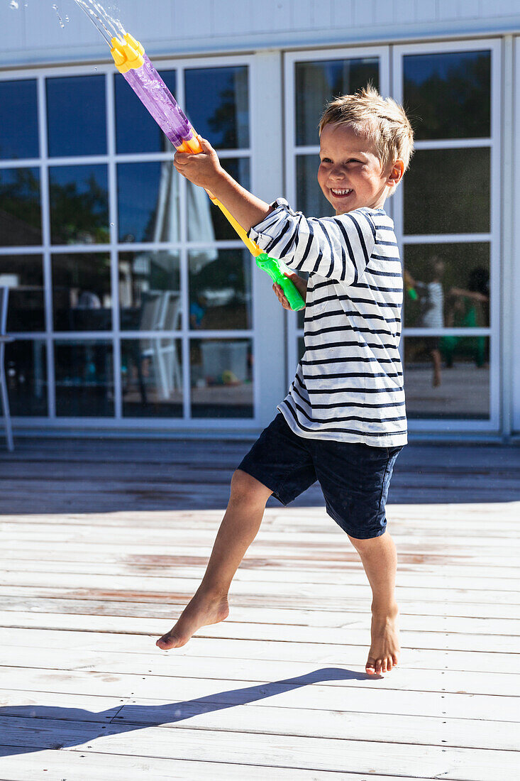 Boy playing with water gun