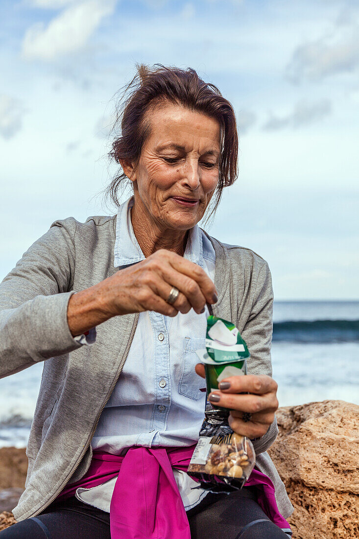 Smiling woman having snack