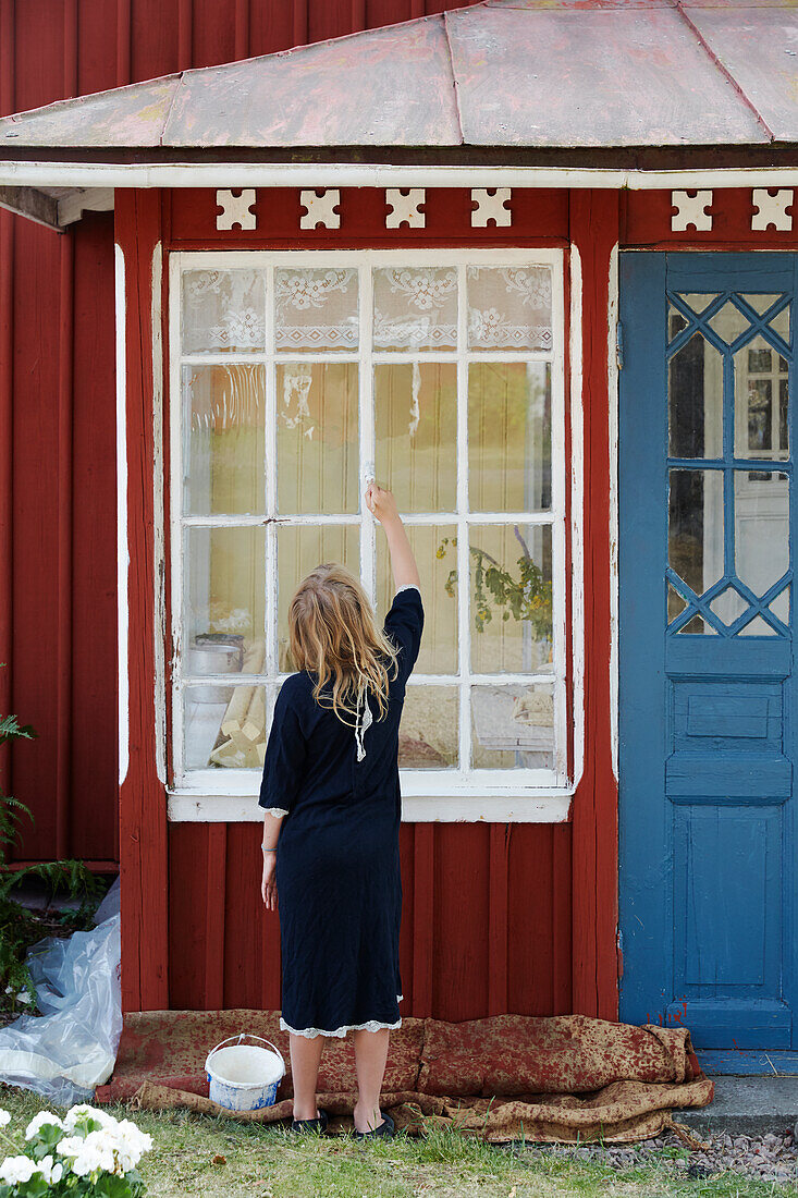 Girl painting windows