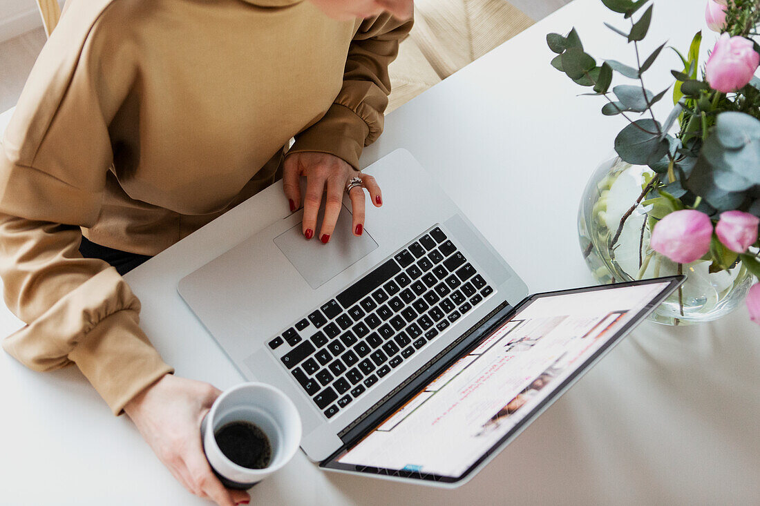 Womans hand using laptop