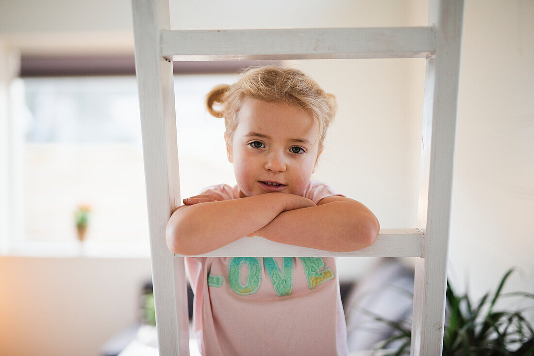 Girl on ladder looking at camera