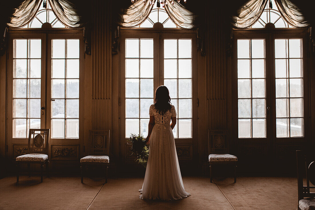 Bride looking through window