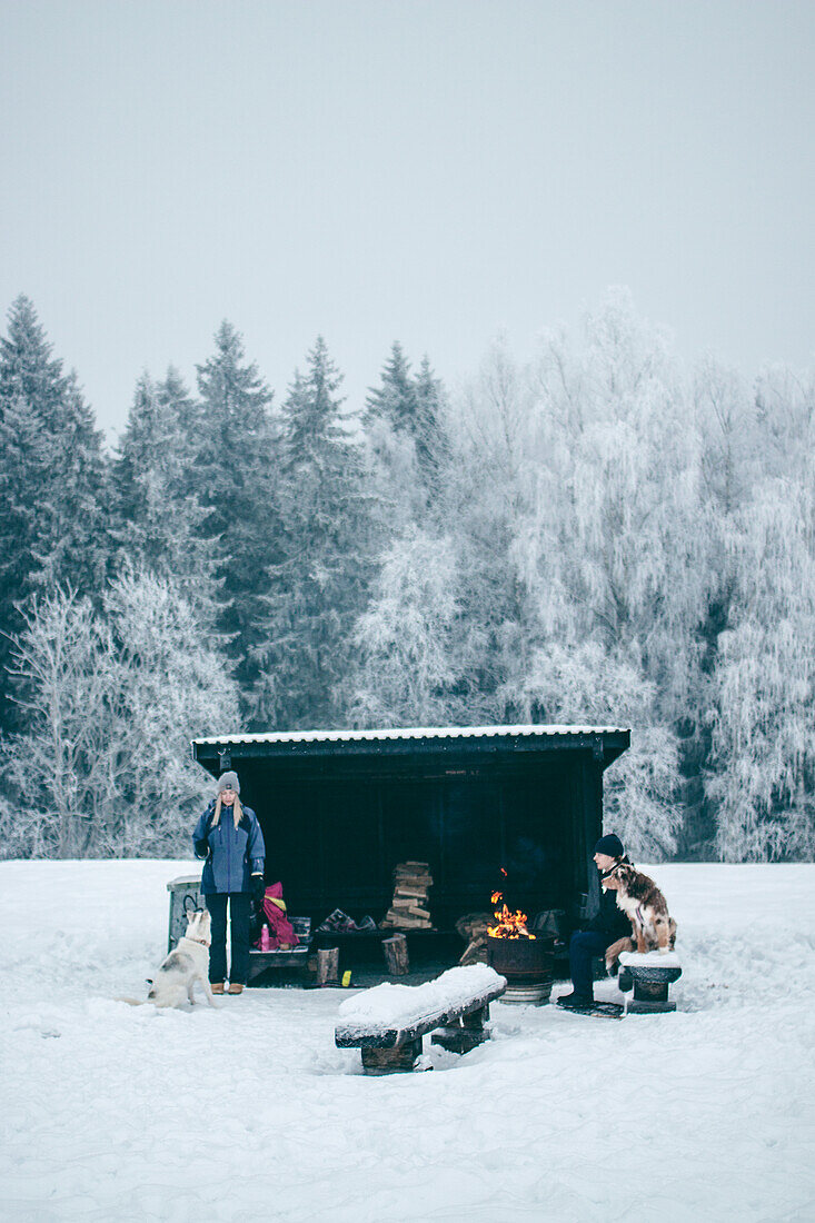 Couple with dogs at shed