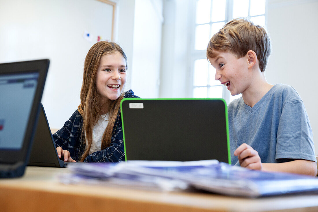 Schoolchildren using laptops