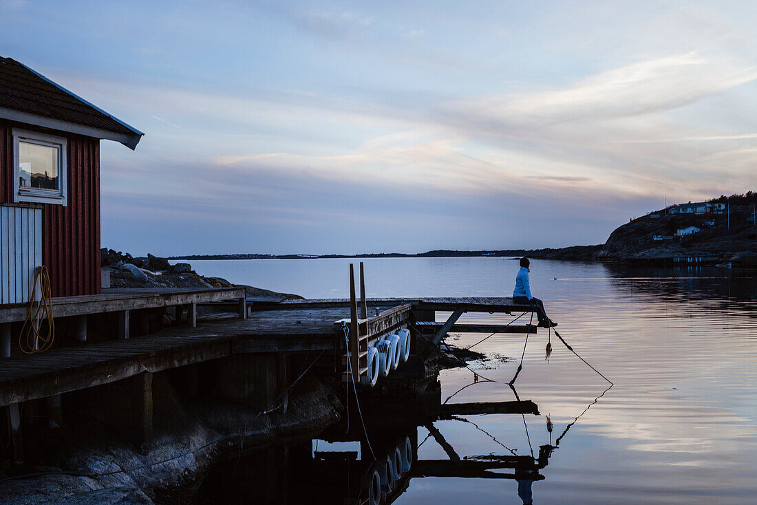 Person on jetty at sea