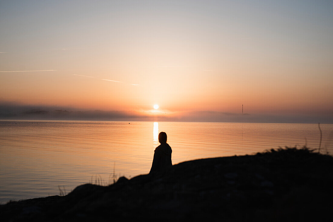 Silhouette of person at sea