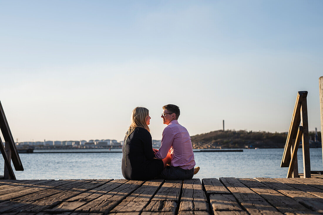 Couple sitting on jetty