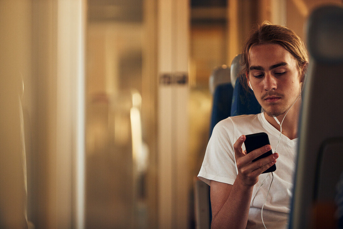 Man using phone in train