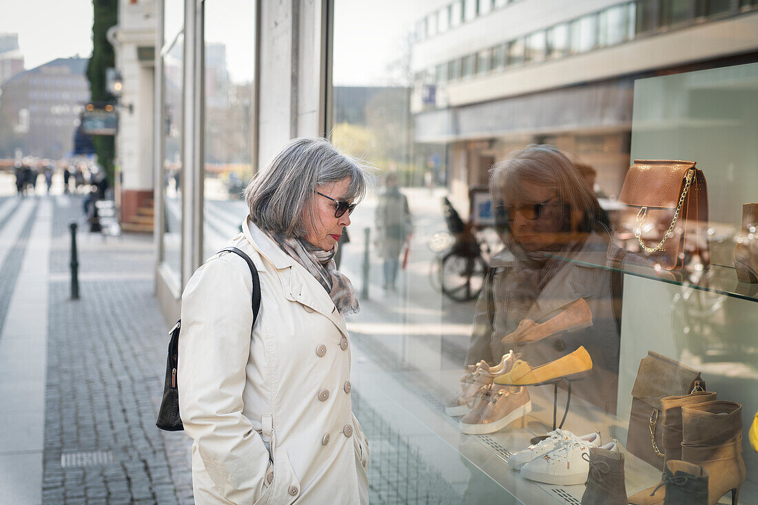 Woman looking in shop window