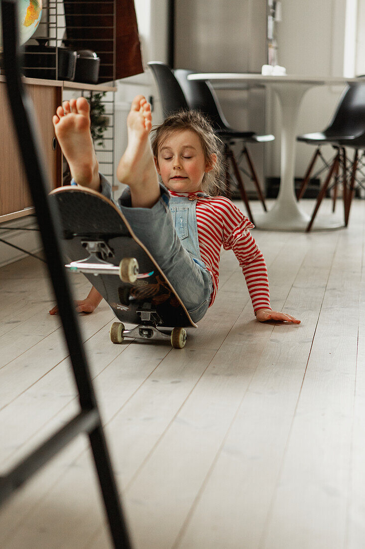Girl falling off skateboard