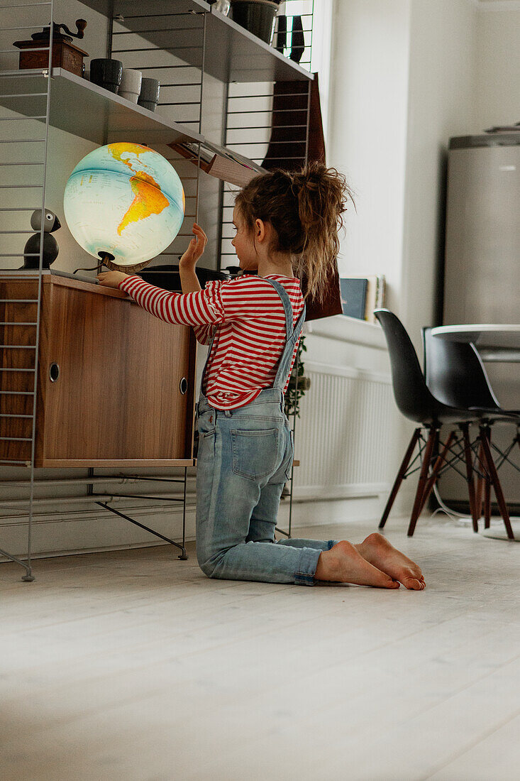 Girl looking at globe