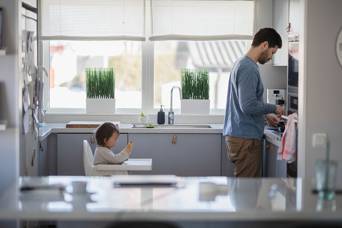 Father with baby in kitchen