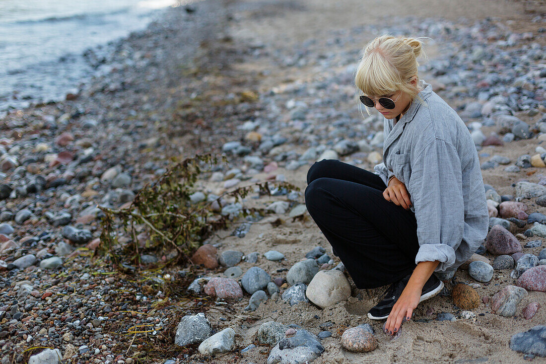 Teenage girl sitting at water