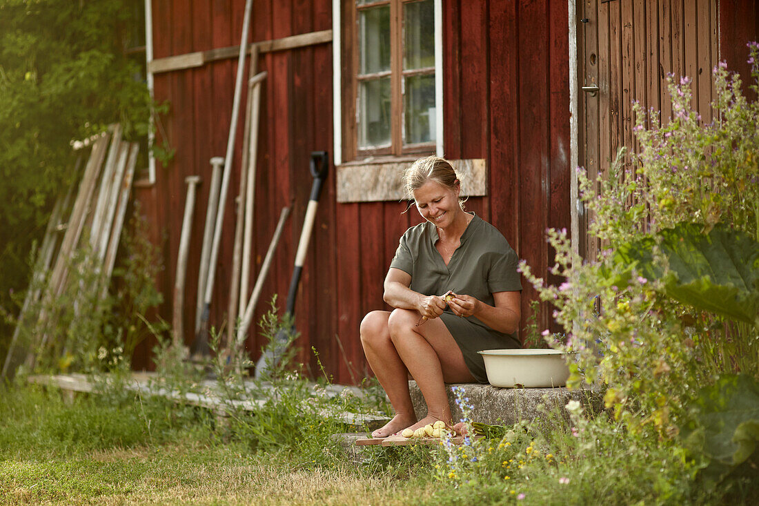 Woman in front of house