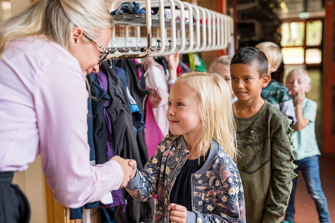 Lehrerin begrüßt Kinder