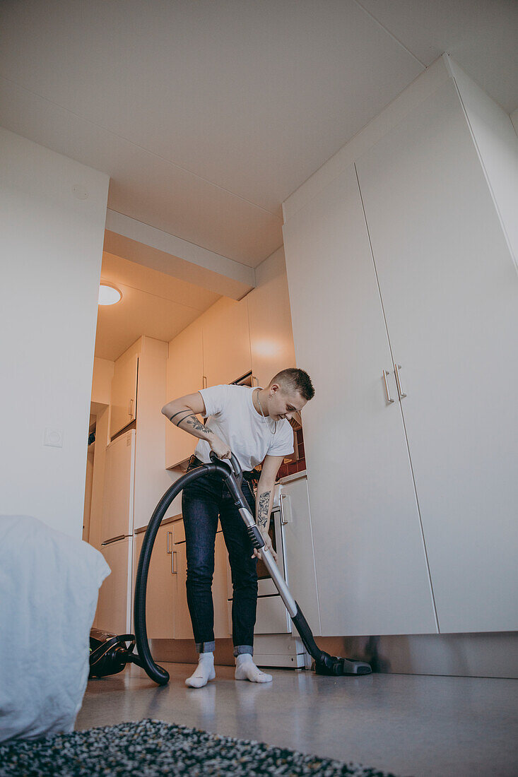 Woman hoovering apartment