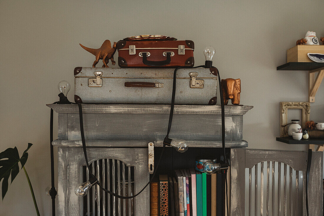 Old-fashioned suitcases on cupboard