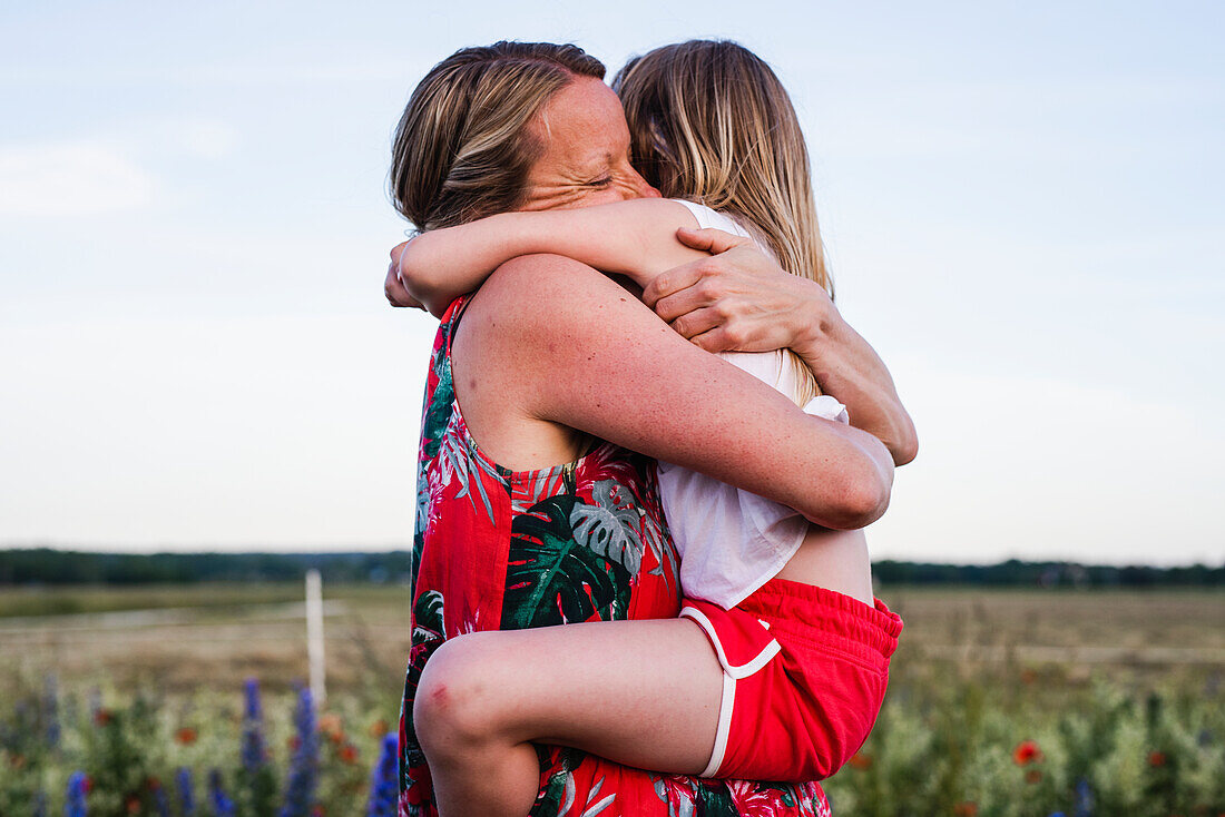 Mother and daughter hugging