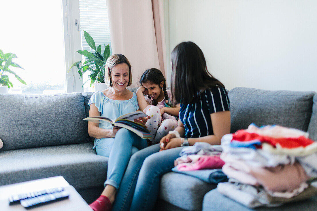 Mothers with daughter on sofa