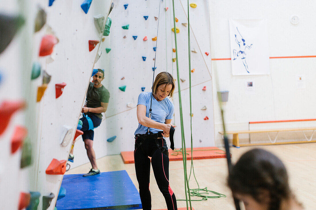 Woman preparing to climb climbing wall