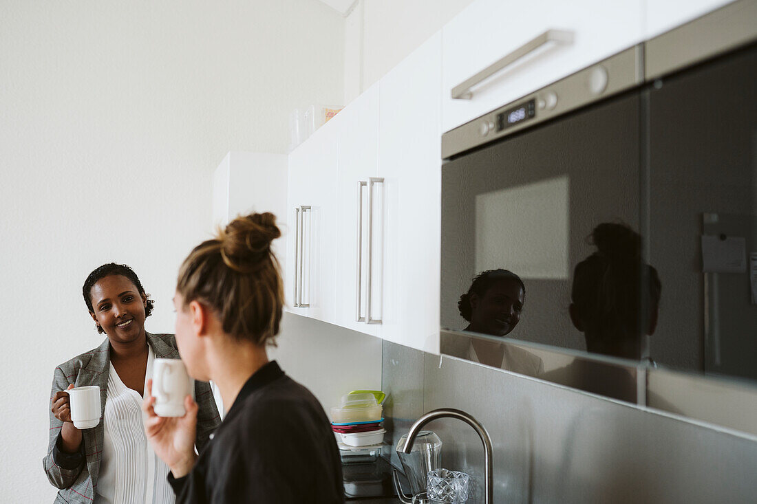 Women having coffee in kitchen