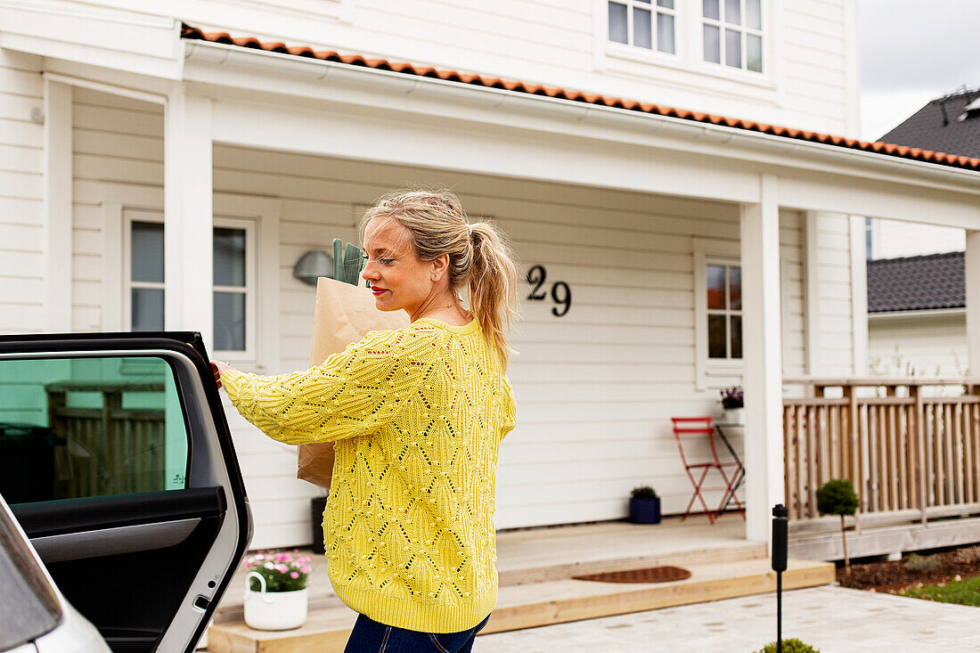 Woman in front of house