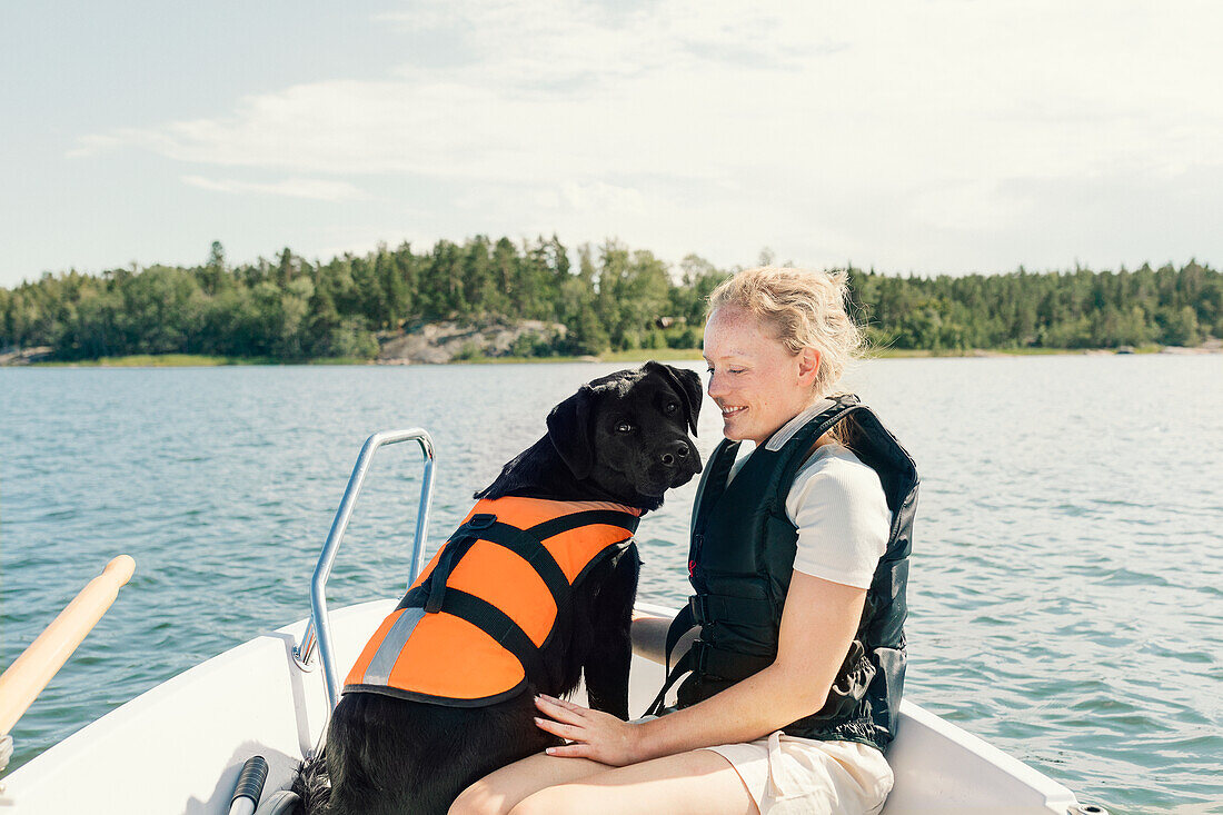 Woman with dog on boat