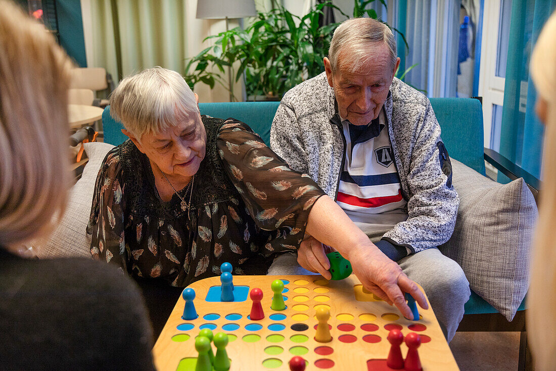 Senior couple playing board game