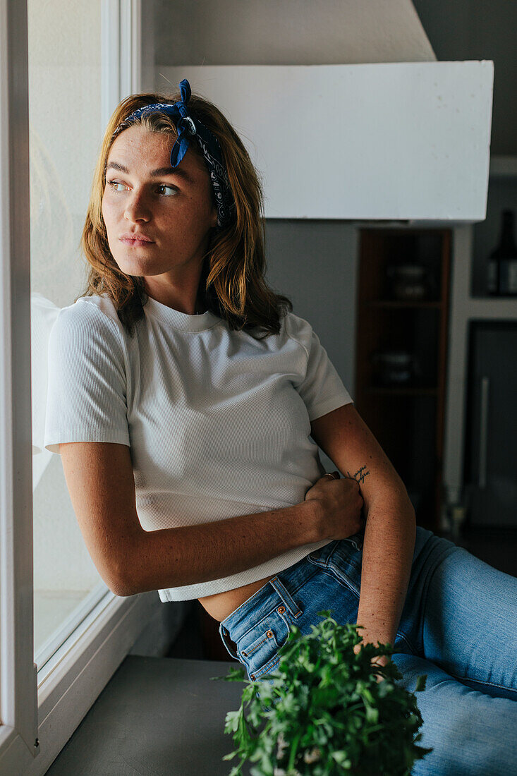 Woman looking through kitchen window