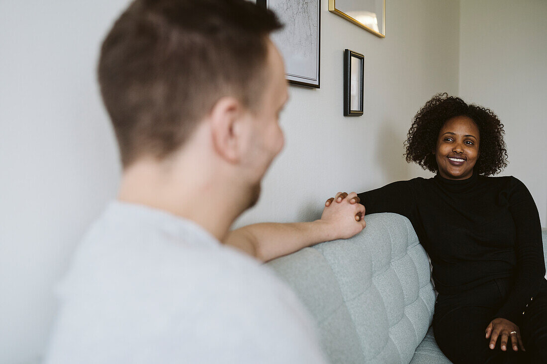 Smiling couple on sofa