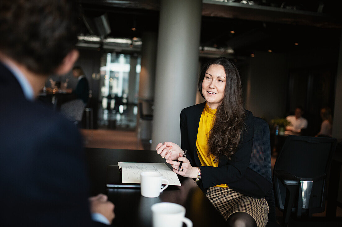 Smiling businesswoman talking in restaurant