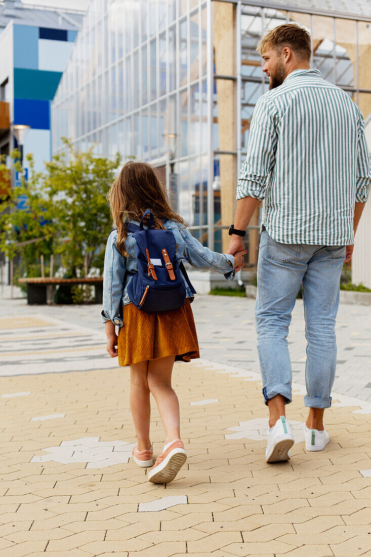 Father walking with daughter