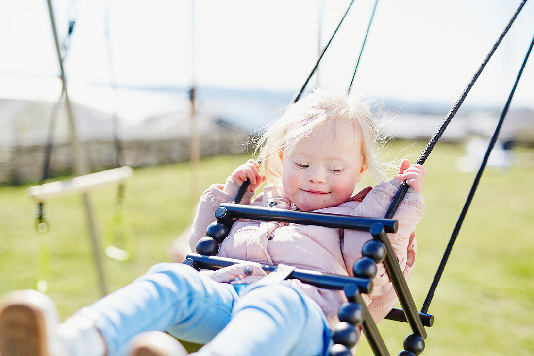 Toddler girl on swing